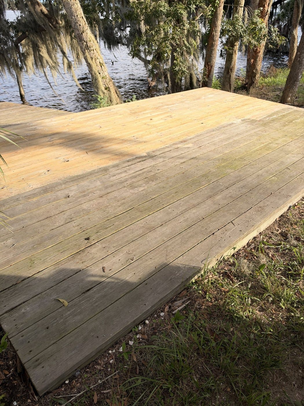 Waterfront wood deck weathered gray before cleaning